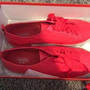 A pair of coach shoes.